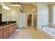 Bathroom featuring double vanity, tub, separate shower, and walk-in closet at 328 Thistlewood Run, Mcdonough, GA 30252
