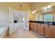 Bathroom featuring double vanities leading to the bedroom with a fireplace at 328 Thistlewood Run, Mcdonough, GA 30252