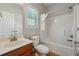 Bathroom featuring a shower-tub combo, sink, and window at 328 Thistlewood Run, Mcdonough, GA 30252