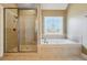 Bathroom featuring a tile shower and a window-side tub with tile surround at 328 Thistlewood Run, Mcdonough, GA 30252