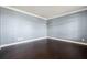 Bedroom with hardwood floors, white trim, and light blue walls at 328 Thistlewood Run, Mcdonough, GA 30252