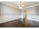 Bright dining room featuring hardwood floors, detailed trim work, and an elegant chandelier at 328 Thistlewood Run, Mcdonough, GA 30252