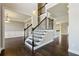 Elegant foyer with hardwood floors and a wrought iron staircase creates a grand entrance at 328 Thistlewood Run, Mcdonough, GA 30252
