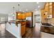 Bright kitchen featuring wooden cabinets, granite countertops, and stainless steel appliances at 328 Thistlewood Run, Mcdonough, GA 30252