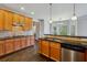 Kitchen features an island with seating, hardwood floors, stainless appliances and great natural light at 328 Thistlewood Run, Mcdonough, GA 30252