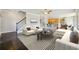 Open concept living room with hardwood floors seamlessly connects to the modern kitchen at 328 Thistlewood Run, Mcdonough, GA 30252