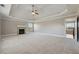 Large main bedroom with fireplace, neutral carpet, and tray ceiling at 328 Thistlewood Run, Mcdonough, GA 30252