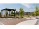 Community green space includes a stage, landscaping, benches and a view of neighborhood buildings at 879 Perennial Dr, Sandy Springs, GA 30328