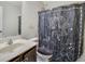 A secondary bathroom featuring a decorative shower curtain, sink, and toilet at 2725 Morgan Glen Rd, Buford, GA 30519