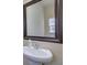Bathroom featuring a pedestal sink, framed mirror, and neutral decor at 2725 Morgan Glen Rd, Buford, GA 30519
