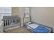 A cozy bedroom featuring a crib and toddler bed, perfect for a young Gathering at 2725 Morgan Glen Rd, Buford, GA 30519