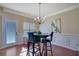 Cozy breakfast nook featuring a modern chandelier and wainscoting at 2725 Morgan Glen Rd, Buford, GA 30519