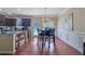 Eat-in kitchen featuring dark cabinetry, granite countertops, and a dining table with modern chairs at 2725 Morgan Glen Rd, Buford, GA 30519
