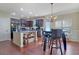 Open kitchen with stainless steel appliances, granite countertops, and hardwood floors at 2725 Morgan Glen Rd, Buford, GA 30519