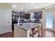 Charming kitchen featuring a large island and dark wood cabinetry at 2725 Morgan Glen Rd, Buford, GA 30519