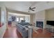 Inviting living room with fireplace, modern ceiling fan, wood floors, and gray sectional sofa at 2725 Morgan Glen Rd, Buford, GA 30519
