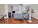 Bright living room with a fireplace, wood floors, and a comfortable gray sectional sofa at 2725 Morgan Glen Rd, Buford, GA 30519