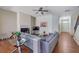 Bright living room with fireplace, modern ceiling fan, wood floors, and gray sectional sofa at 2725 Morgan Glen Rd, Buford, GA 30519