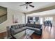 Cozy living room with wood floors, modern sectional sofa, and open access to the kitchen and dining area at 2725 Morgan Glen Rd, Buford, GA 30519