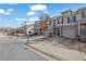 Charming street view of townhomes with garages, well-maintained landscaping, and inviting curb appeal at 2725 Morgan Glen Rd, Buford, GA 30519