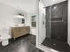 Modern bathroom featuring black marble tile flooring, double vanity, and a glass-enclosed shower at 2704 Ellen Way, Decatur, GA 30032