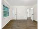 A clean, empty bedroom with light hardwood floors, a large window and fresh paint at 2704 Ellen Way, Decatur, GA 30032