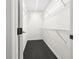 A walk-in closet with dark floors and white shelving at 2704 Ellen Way, Decatur, GA 30032