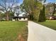 Front view of a cozy home showcasing a long driveway and verdant lawn at 2704 Ellen Way, Decatur, GA 30032