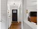 Bright entryway with hardwood floors, white console table, and dark brown front door at 3741 Hickory Se Cir, Smyrna, GA 30080