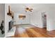 Bright living room featuring hardwood floors, fireplace, and ceiling fan at 3741 Hickory Se Cir, Smyrna, GA 30080