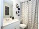 Bathroom with white vanity, decorative mirror, and stylish geometric shower curtain at 40 Eryn Ter, Covington, GA 30014