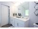 Bright bathroom with white cabinets, double sinks, modern fixtures and decor at 40 Eryn Ter, Covington, GA 30014