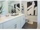 A modern bathroom features double sinks, stylish artwork, and a glass-enclosed shower at 40 Eryn Ter, Covington, GA 30014