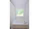 Inviting bathtub in a bright bathroom with frosted window and chrome fixtures at 40 Eryn Ter, Covington, GA 30014
