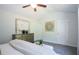 Bright bedroom features a ceiling fan, dresser, artwork and neutral decor at 40 Eryn Ter, Covington, GA 30014