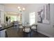 Bright dining area features modern chandelier, glass top table and seating for four at 40 Eryn Ter, Covington, GA 30014