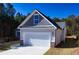Two-car garage with white doors and stone accents at 40 Eryn Ter, Covington, GA 30014
