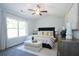 A well-lit main bedroom with a ceiling fan, large window, and neutral color palette at 40 Eryn Ter, Covington, GA 30014