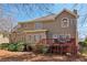 Exterior view of the home featuring a deck, large windows, and a well-maintained yard at 1150 Cedar Bluff Sw Trl, Lilburn, GA 30047