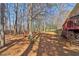 The large backyard features mature trees offering shade and privacy at 1150 Cedar Bluff Sw Trl, Lilburn, GA 30047