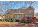 Spacious backyard view showcasing the deck and the home's upper and lower level at 1150 Cedar Bluff Sw Trl, Lilburn, GA 30047