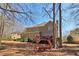 The backyard features mature trees, a swing, a spacious lawn, and a deck at 1150 Cedar Bluff Sw Trl, Lilburn, GA 30047