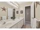 Bathroom featuring a double sink vanity with ample counter space, complemented by decorative accents and soft lighting at 1150 Cedar Bluff Sw Trl, Lilburn, GA 30047