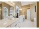 Bright bathroom featuring double vanity, tiled flooring, soaking tub, and large windows at 1150 Cedar Bluff Sw Trl, Lilburn, GA 30047