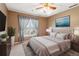 Cozy bedroom featuring a large bed, soft carpet, and a window with curtains providing natural light at 1150 Cedar Bluff Sw Trl, Lilburn, GA 30047