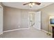 Tan carpeted bedroom with one window, ceiling fan, standard closet and light tan walls at 1150 Cedar Bluff Sw Trl, Lilburn, GA 30047