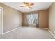 Standard bedroom offering neutral tones and a window with curtains, ceiling fan, providing ample natural light at 1150 Cedar Bluff Sw Trl, Lilburn, GA 30047