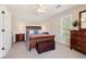 Bedroom featuring a wooden sleigh bed, dresser, and natural light from the window, creating a cozy atmosphere at 1150 Cedar Bluff Sw Trl, Lilburn, GA 30047