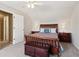 Comfortable bedroom with a wood-framed bed, matching nightstands, and a charming storage chest at the foot of the bed at 1150 Cedar Bluff Sw Trl, Lilburn, GA 30047