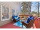 Outdoor deck setting with comfortable seating and a view of the surrounding trees at 1150 Cedar Bluff Sw Trl, Lilburn, GA 30047